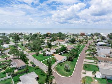 An aerial view showcases the property near the beach with a vibrant neighborhood and clear property lines at 1580 Arizona Ave Ne, St Petersburg, FL 33703