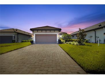 Charming single-Gathering home featuring a tile roof, attached garage and manicured landscaping at 3312 Francoa Dr, Odessa, FL 33556