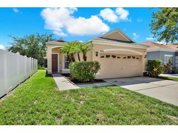 Charming single-story home with well-manicured lawn and attached two-car garage at 406 Laguna Mill Dr, Ruskin, FL 33570