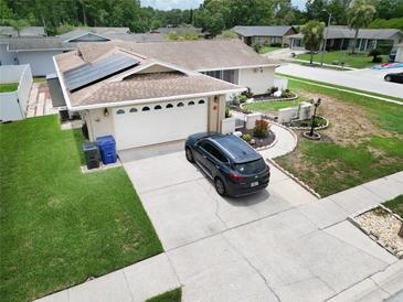 Inviting single Gathering home featuring a two-car garage, solar panels, and well-maintained landscaping at 8110 Damara Dr, New Port Richey, FL 34653