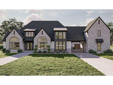 Beautiful home boasts stone accents, an attached garage, and professionally landscaped front yard at 125 Avonwood, Tampa, FL 33625