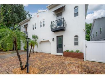 Charming two-story home showcasing a well-kept exterior, black awnings and brick driveway at 403 S Fremont Ave # 3, Tampa, FL 33606
