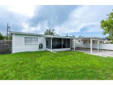 Single story home with a cozy enclosed patio and a convenient carport at 4705 Murray Hill Dr, Tampa, FL 33615
