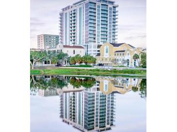 Reflective waterfront view of high-rise residential building with surrounding architecture at 777 3Rd N Ave # 1703, St Petersburg, FL 33701