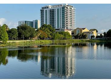 A picturesque view of the building from across the serene lake at 777 3Rd N Ave # 1704, St Petersburg, FL 33701