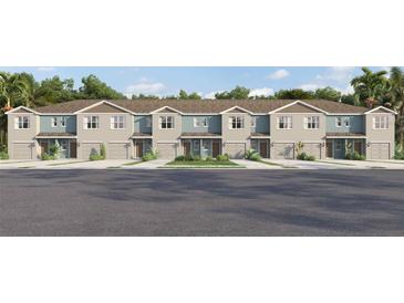 Charming townhomes featuring Craftsman architecture, attached garages, and beautifully landscaped common areas at 961 Spotted Egret Loop, Ruskin, FL 33570