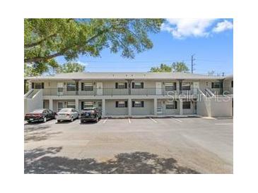 Two-story condominium building featuring individual balconies and ample parking at 101 Lake Ne Ave # 121, Largo, FL 33771