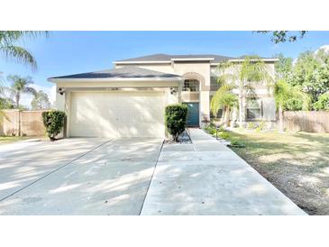 Two-story home features a well-manicured lawn, driveway, and a two car garage at 10924 Summerton Dr, Riverview, FL 33579