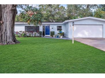 Charming single-story home with a well-manicured lawn and lush landscaping at 1384 S Hillcrest Ave, Clearwater, FL 33756