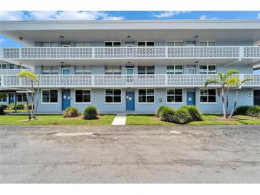 Inviting building with well-maintained lawn and blue doors, offering a welcoming curb appeal at 4895 Bay Ne St # 207, St Petersburg, FL 33703