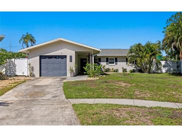 Charming single-story home with a well-manicured front yard and a one-car garage at 529 59Th S Way, St Petersburg, FL 33707