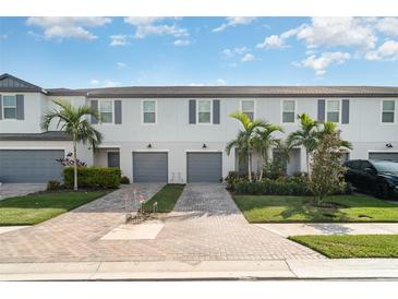 Inviting townhomes feature lush landscaping, brick driveways, and attached garages at 5519 Tripoli Dr, Palmetto, FL 34221