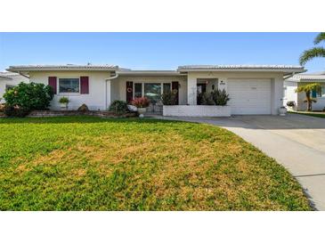 Charming single-story home featuring a well-manicured lawn and inviting curb appeal at 9548 141St St, Seminole, FL 33776