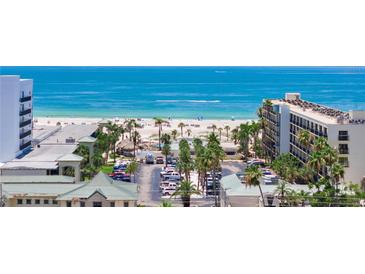 Scenic view of the beach and ocean from beachfront condo with palm trees and resort-style amenities at 5353 Gulf Blvd # A402, St Pete Beach, FL 33706
