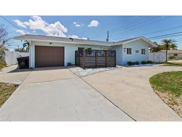 Charming single-story home with a private front yard and attached garage at 2 79Th S St, St Petersburg, FL 33707