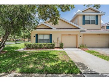 Charming townhome with a well-manicured lawn and inviting curb appeal at 20302 Noble Oak Pl, Tampa, FL 33647