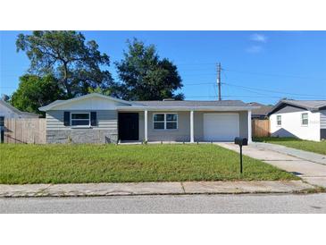 Charming single-story home with a well-maintained front yard and a classic exterior at 3150 Beacon Square Dr, Holiday, FL 34691