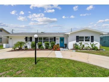 Charming single-story home featuring a bright blue front door and well-maintained landscaping at 3545 59Th N Ln, St Petersburg, FL 33710