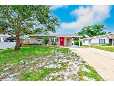 Charming single-story home featuring a well-maintained lawn and a vibrant red front door at 6237 50Th N Ave, St Petersburg, FL 33709