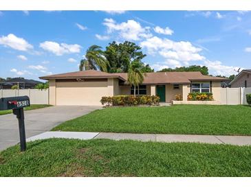 Charming single-story home with well-maintained lawn, mature landscaping, and a cozy, inviting curb appeal at 6530 68Th N St, Pinellas Park, FL 33781