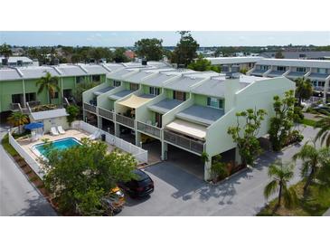 Charming townhomes with a shared pool, private carports, and balconies for outdoor living at 318 Windrush Blvd # 10, Indian Rocks Beach, FL 33785