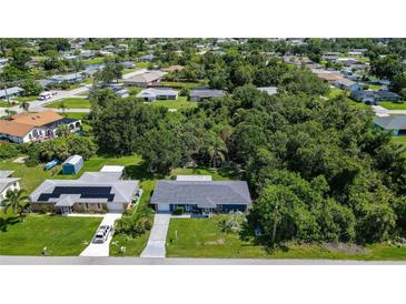 Beautiful aerial view of home with lush greenery, solar panels, and well-maintained landscaping at 22442 Vale Ave, Punta Gorda, FL 33980