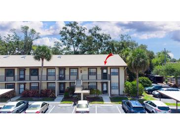 Exterior of a charming condo building with well-maintained landscaping, balconies, and convenient parking spaces at 2400 Winding Creek Blvd # Bldg18A210, Clearwater, FL 33761