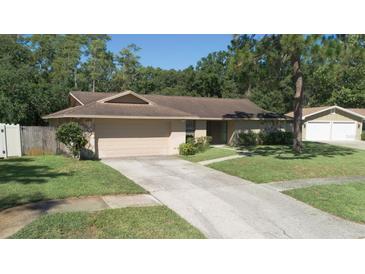 Charming single-story home with a well-maintained lawn and attached two-car garage at 2532 Sweetgum W Way, Clearwater, FL 33761