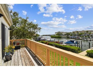 Enjoy the view of the marina from this cozy outdoor balcony with wood flooring and a decorative wood railing at 4304 Harbor House Dr, Tampa, FL 33615