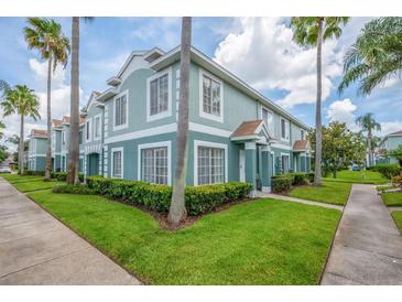 Inviting two-story townhouse featuring neat landscaping, mature palms, and a clean, modern color palette at 1312 Kelridge Pl, Brandon, FL 33511