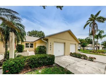Charming single-Gathering home with a two-car garage and tropical landscaping at 1902 Elaine Dr, Clearwater, FL 33760