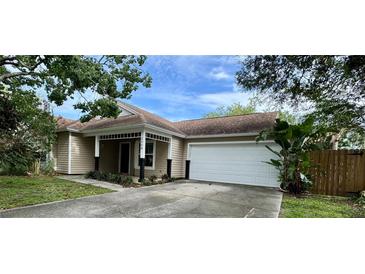 Charming single-story home with a well-maintained lawn, a two car garage and inviting front porch at 2068 Diane Ave, Palm Harbor, FL 34683