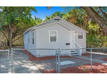 Charming single-story home with a neutral color scheme and a well-maintained yard behind a chainlink fence at 2926 Fairfield S Ave, St Petersburg, FL 33712