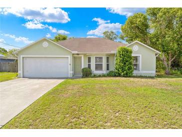 Charming single-story home with a well-manicured lawn and attached two-car garage at 3485 Dothan Ave, Spring Hill, FL 34609