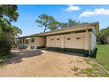 Charming single-story home with a two-car garage and gravel driveway at 5391 54Th N St, St Petersburg, FL 33709