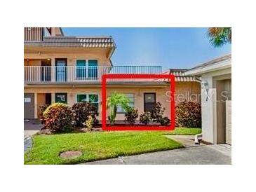 A condominium building featuring well-kept landscaping and a welcoming entrance at 6400 46Th N Ave # 121, Kenneth City, FL 33709