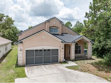 Charming two-story home featuring a spacious two-car garage and inviting front porch at 8050 Diablo Ct, Trinity, FL 34655