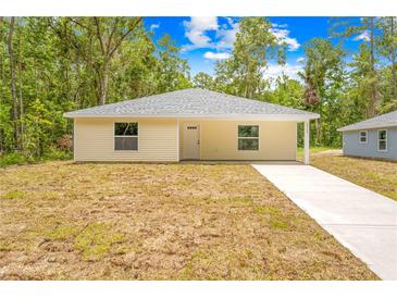 Charming single story home boasts a tidy yard and convenient driveway for easy access at 19267 Wildwood Dr, Brooksville, FL 34601