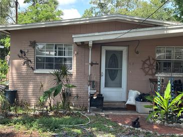 Charming single-story home with a quaint entryway and mature landscaping at 6817 S Wall St, Tampa, FL 33616