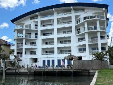 Stunning multi-story waterfront condo with a private dock, tiki huts, and stunning architectural details at 100 Bayside Dr # 202, Clearwater Beach, FL 33767