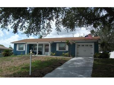 Charming single-story home with blue siding, white trim, and an attached two-car garage at 12411 Brookside St, Spring Hill, FL 34609