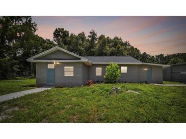 Charming single-story home with gray siding, well-maintained lawn, and inviting curb appeal at 2812 Tom Brewer Ln, Plant City, FL 33566