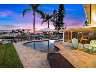 Beautiful waterfront pool and patio area perfect for entertaining guests and watching the sunset at 4252 Floramar Ter, New Port Richey, FL 34652