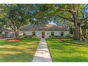Charming single-story home with lush lawn and mature trees at 4708 W Neptune St, Tampa, FL 33629