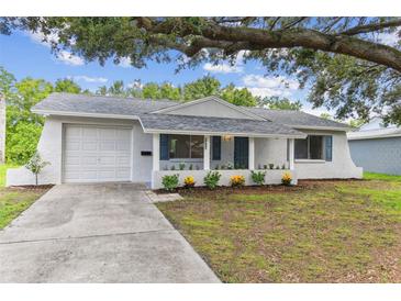 Charming single-story home with a well-maintained yard, covered porch, and attached garage at 9936 62Nd N St, Pinellas Park, FL 33782