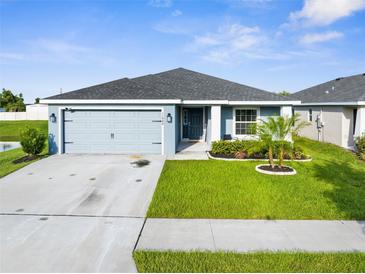Charming single-story home features a well-manicured lawn and attached two-car garage at 11940 Stone Pine St, Riverview, FL 33569
