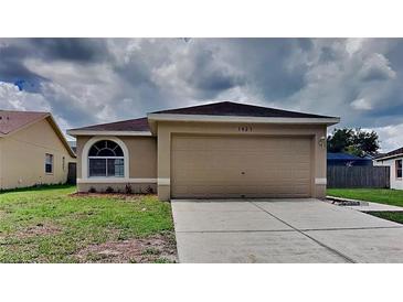 Charming single-story home with a well-maintained lawn and attached two-car garage at 1421 Mohrlake Dr, Brandon, FL 33511