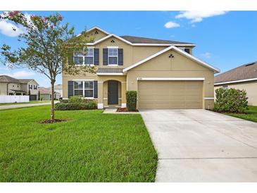 Inviting two-story home featuring a manicured lawn and a neutral-toned facade at 3125 S Northview Rd, Plant City, FL 33566