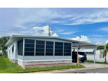 Charming single-story home with a screened-in porch and covered parking area at 34645 Camphor N Dr, Pinellas Park, FL 33781