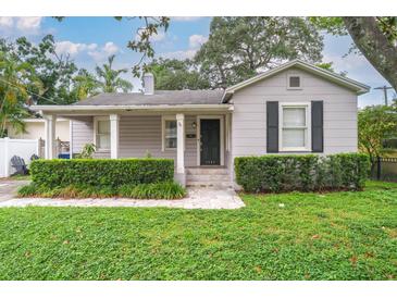 Charming single-story home with a well-manicured lawn and classic architectural details at 3503 W Palmira Ave, Tampa, FL 33629